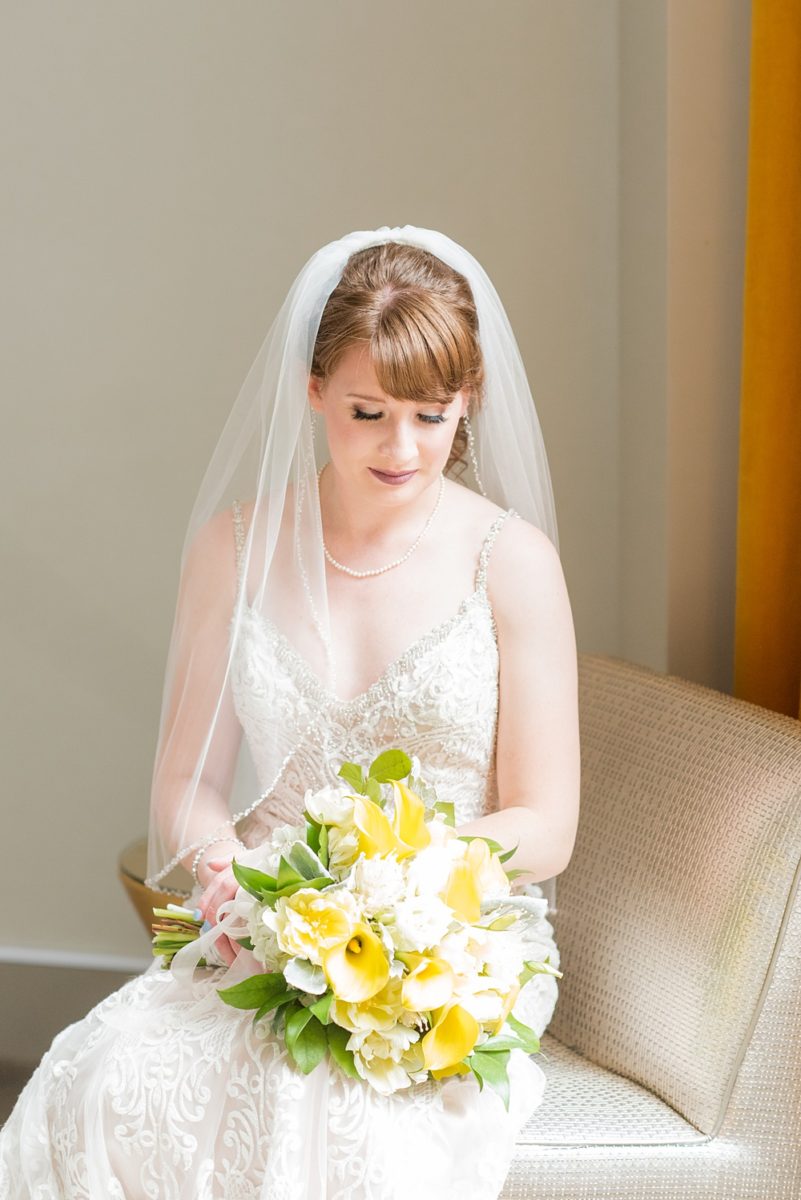 Pictures at a Durham, North Carolina wedding venue by Mikkel Paige Photography. The Rickhouse was the perfect indoor space for the bride and groom's ceremony + reception. They got ready at 21c Museum hotel and took beautiful outdoor photos in the summer sun. The bride chose yellow for her bouquet and a lace v-neck gown for her style. #mikkelpaige #therickhouse #durhamweddingphotos #durhamwedding #northcarolinaweddingphotographer #durhamweddingphotographer #blueandyellow #summerwedding #lacegown