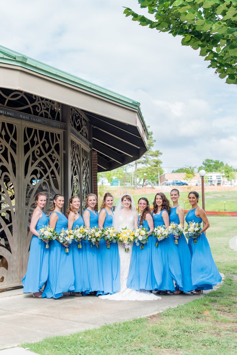 Pictures at a Durham, North Carolina wedding venue by Mikkel Paige Photography. The Rickhouse was a perfect indoor space for the bride and groom's ceremony + reception. They got ready at 21c Museum hotel and took beautiful outdoor photos in the summer sun. The couple chose fun yellow hues for the bouquets and a Carolina blue for beautiful bridesmaids gowns. #mikkelpaige #therickhouse #durhamweddingphotos #durhamwedding #northcarolinaweddingphotographer #durhamweddingphotographer #bluebridesmaids