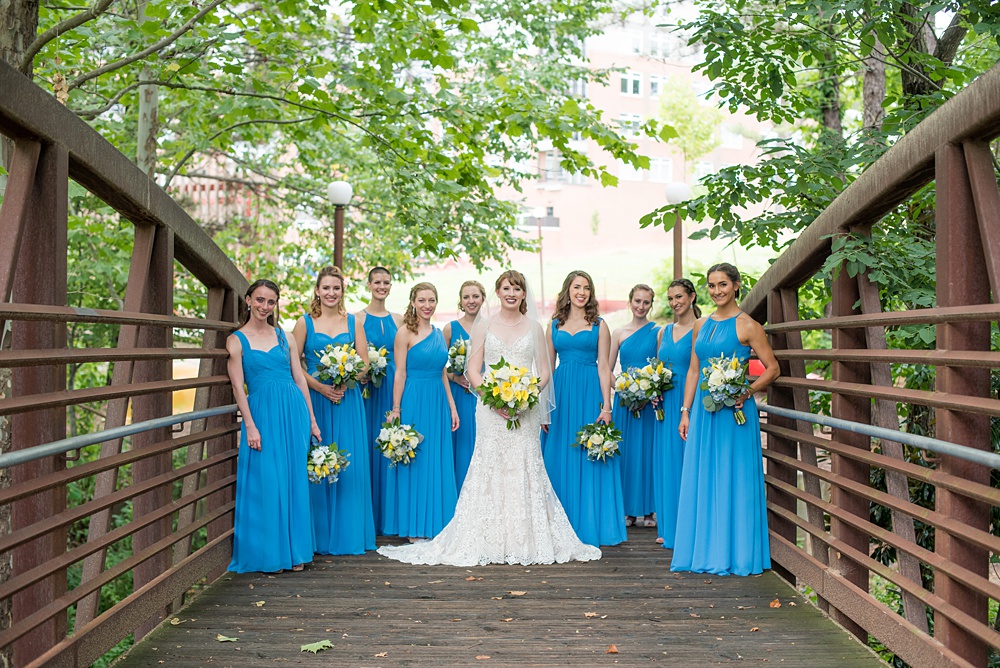 Pictures at a Durham, North Carolina wedding venue by Mikkel Paige Photography. The Rickhouse was a perfect indoor space for the bride and groom's ceremony + reception. They got ready at 21c Museum hotel and took beautiful outdoor photos in the summer sun. The couple chose fun yellow hues for the bouquets and a Carolina blue for beautiful bridesmaids gowns. #mikkelpaige #therickhouse #durhamweddingphotos #durhamwedding #northcarolinaweddingphotographer #durhamweddingphotographer #bluebridesmaids