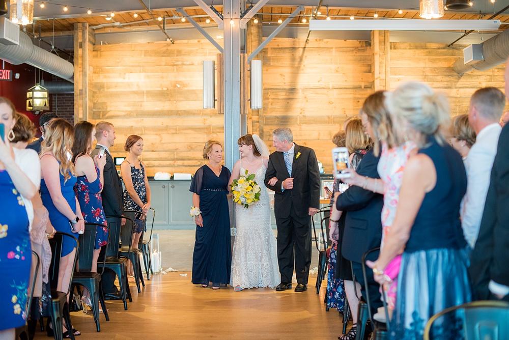 Pictures at a Durham, North Carolina wedding venue by Mikkel Paige Photography. The Rickhouse was the perfect outdoor/indoor space for the bride and groom's reception and ceremony. The couple chose fun yellow and blue colors for their summer decor. #mikkelpaige #therickhouse #durhamweddingphotos #durhamwedding #northcarolinaweddingphotographer #durhamweddingphotographer