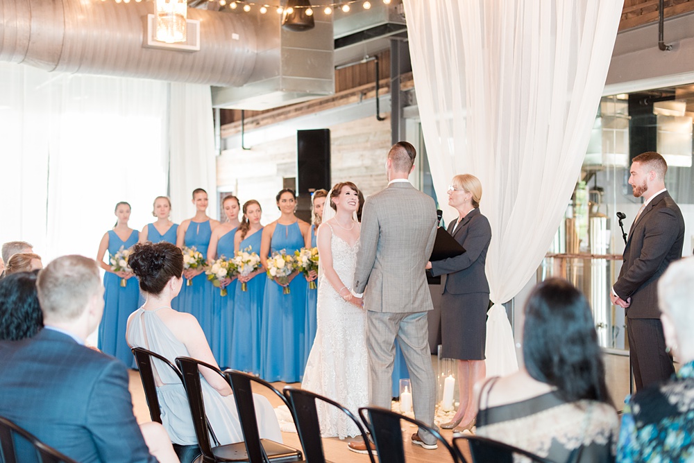 Pictures at a Durham, North Carolina wedding venue by Mikkel Paige Photography. The Rickhouse was the perfect outdoor/indoor space for the bride and groom's reception and ceremony. The couple chose fun yellow and blue colors for their summer decor. #mikkelpaige #therickhouse #durhamweddingphotos #durhamwedding #northcarolinaweddingphotographer #durhamweddingphotographer