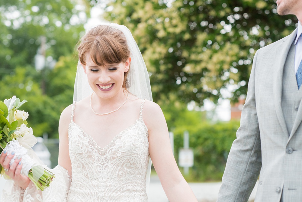 Pictures at a Durham, North Carolina wedding venue by Mikkel Paige Photography. The Rickhouse was the perfect indoor space for the bride and groom's ceremony and reception. They got ready at 21c Museum hotel and took beautiful outdoor photos in the summer sun. The couple chose fun yellow and blue colors for beautiful reception decor. #mikkelpaige #therickhouse #durhamweddingphotos #durhamwedding #northcarolinaweddingphotographer #durhamweddingphotographer #blueandyellow #summerwedding