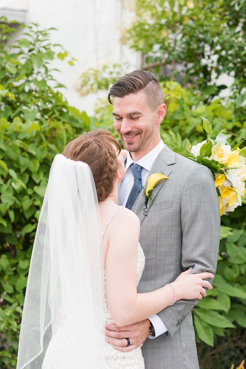 Pictures at a Durham, North Carolina wedding venue by Mikkel Paige Photography. The Rickhouse was the perfect indoor space for the bride and groom's ceremony and reception. They got ready at 21c Museum hotel and took beautiful outdoor photos in the summer sun. The couple chose fun yellow and blue colors for beautiful reception decor. #mikkelpaige #therickhouse #durhamweddingphotos #durhamwedding #northcarolinaweddingphotographer #durhamweddingphotographer #blueandyellow #summerwedding