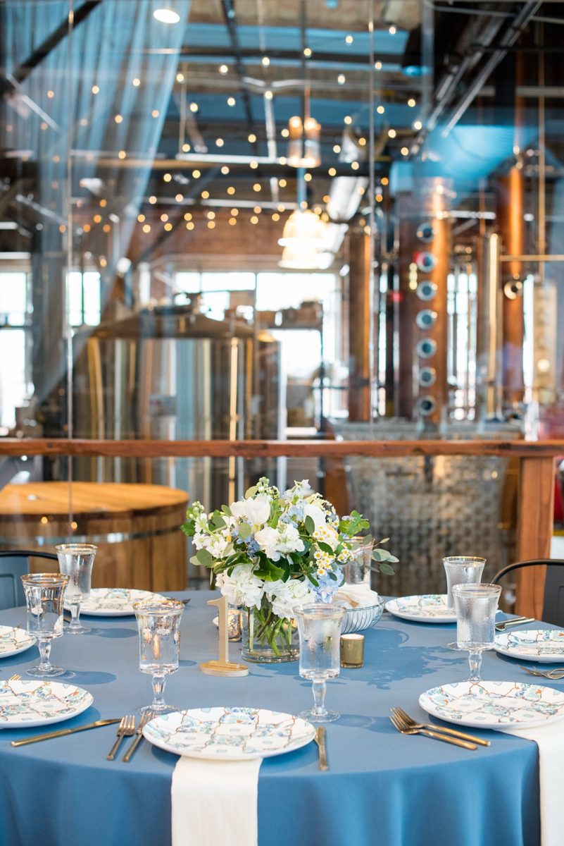 Pictures at a Durham, North Carolina wedding venue by Mikkel Paige Photography. The Rickhouse was the perfect outdoor/indoor space for the bride and groom's celebration. The couple chose fun yellow and blue colors for their summer reception and simple yet beautiful reception decor. #mikkelpaige #therickhouse #durhamweddingphotos #durhamwedding #northcarolinaweddingphotographer #durhamweddingphotographer #blueandyellow #summerwedding