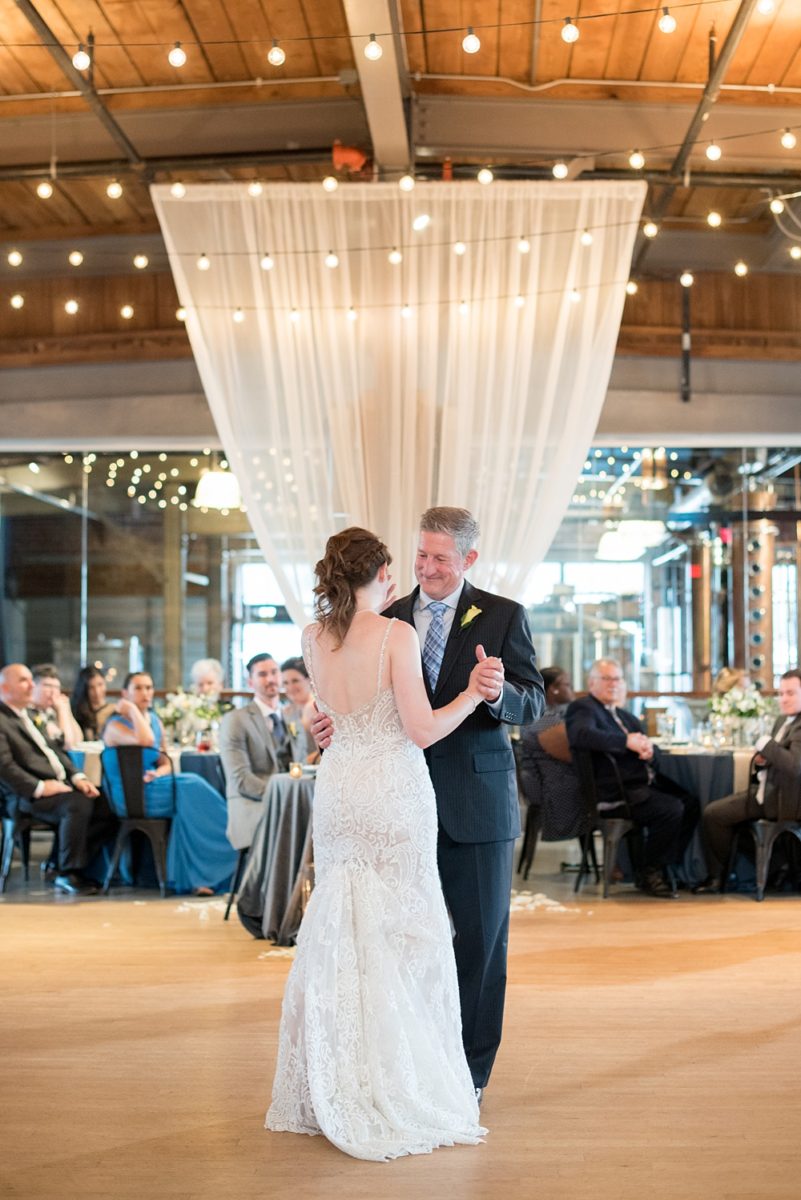 Pictures at a Durham, North Carolina wedding venue by Mikkel Paige Photography. The Rickhouse was the perfect outdoor/indoor space for the bride and groom's reception and ceremony. The couple chose fun yellow and blue colors for their summer decor. #mikkelpaige #therickhouse #durhamweddingphotos #durhamwedding #northcarolinaweddingphotographer #durhamweddingphotographer