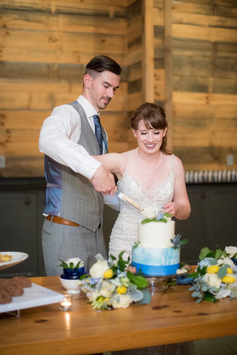 Pictures at a Durham, North Carolina wedding venue by Mikkel Paige Photography. The Rickhouse was the perfect outdoor/indoor space for the bride and groom's reception and ceremony. The couple chose fun yellow and blue colors for their summer decor and their small buttercream cake matched with ombre marble designs and floral decorations. #mikkelpaige #therickhouse #durhamweddingphotos #durhamwedding #northcarolinaweddingphotographer #durhamweddingphotographer