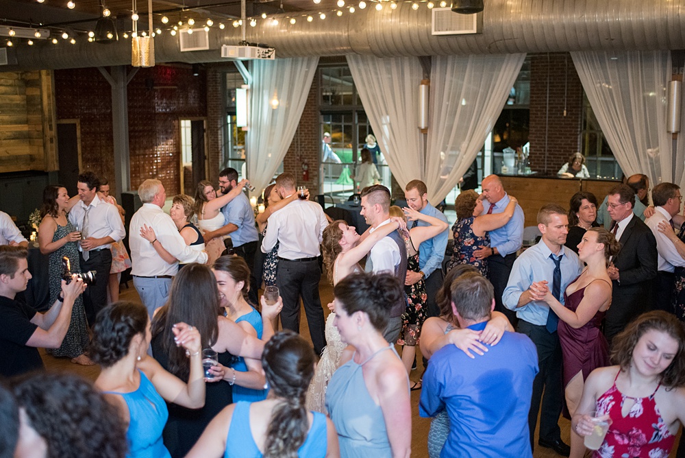 Pictures at a Durham, North Carolina wedding venue by Mikkel Paige Photography. The Rickhouse was the perfect outdoor/indoor space for the bride and groom's reception and ceremony. The couple chose fun yellow and blue colors for their summer decor. #mikkelpaige #therickhouse #durhamweddingphotos #durhamwedding #northcarolinaweddingphotographer #durhamweddingphotographer