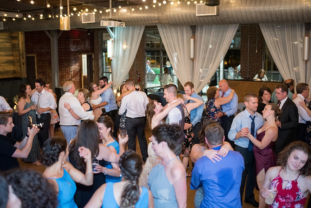 Pictures at a Durham, North Carolina wedding venue by Mikkel Paige Photography. The Rickhouse was the perfect outdoor/indoor space for the bride and groom's reception and ceremony. The couple chose fun yellow and blue colors for their summer decor. #mikkelpaige #therickhouse #durhamweddingphotos #durhamwedding #northcarolinaweddingphotographer #durhamweddingphotographer