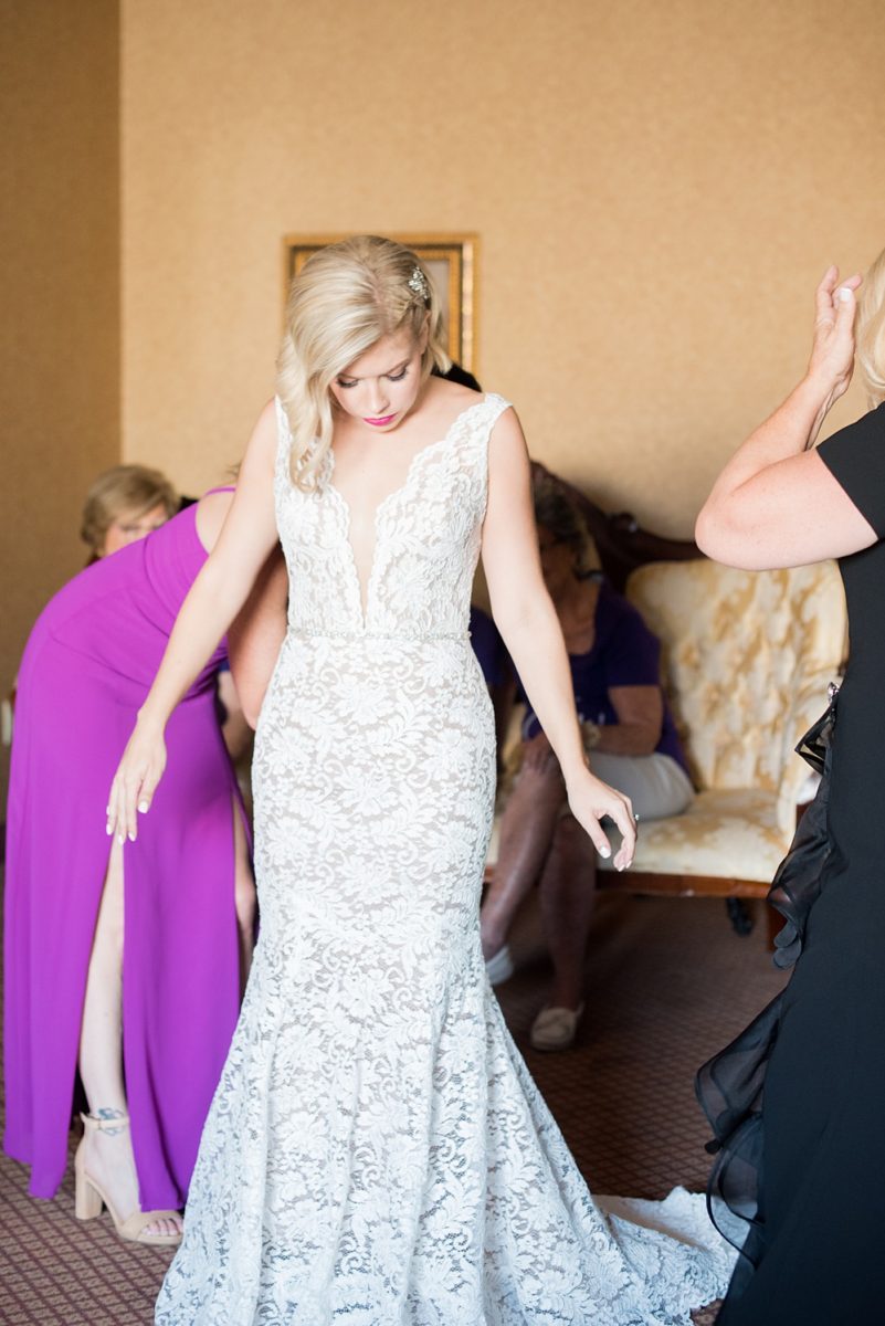 Photos of the bride and her maid of honor getting ready on Long Island by Mikkel Paige Photography for her East Wind wedding in Wading River, NY. The wedding venue has a beautiful outdoor ceremony area and pretty indoor reception space. #mikkelpaige #newyorkweddingphotographer #longislandweddingvenue #summerbride #laceweddinggown #bridestyle #weddingdetails #gettingready