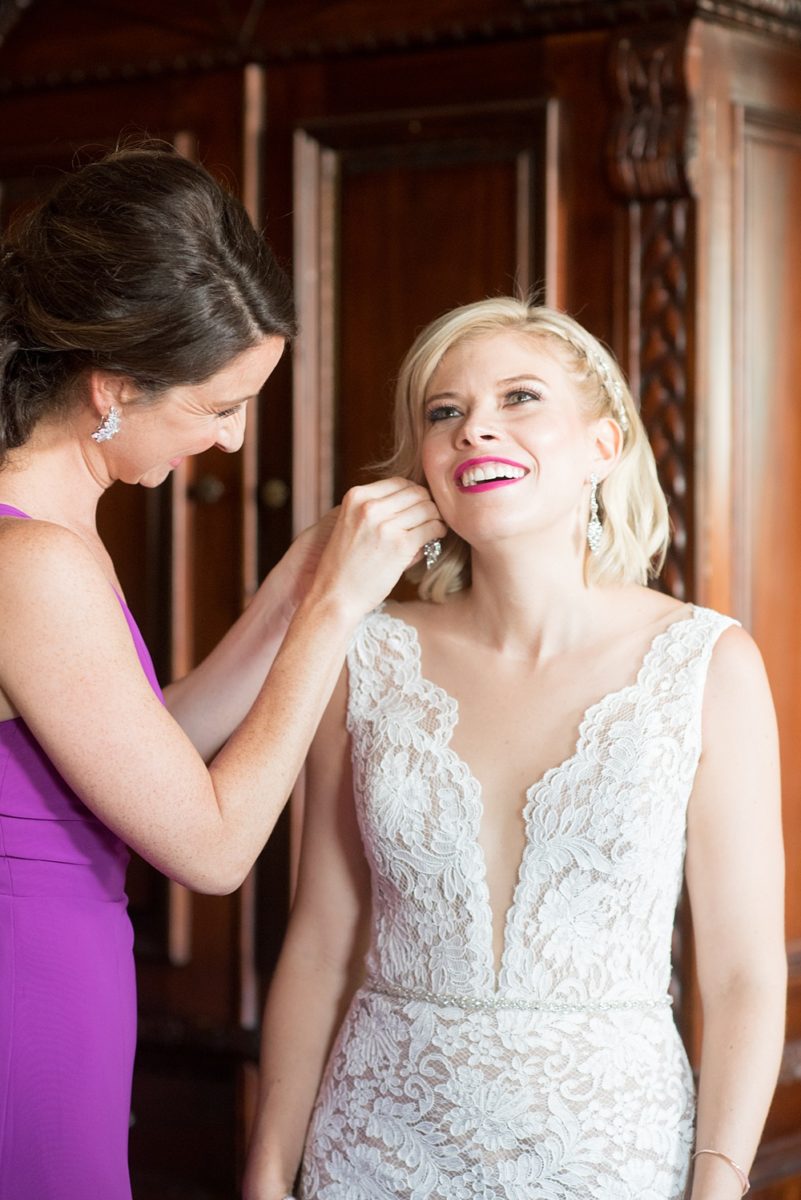 Photos of the bride and her maid of honor getting ready on Long Island by Mikkel Paige Photography for her East Wind wedding in Wading River, NY. The wedding venue has a beautiful outdoor ceremony area and pretty indoor reception space. #mikkelpaige #newyorkweddingphotographer #longislandweddingvenue #summerbride #laceweddinggown #bridestyle #weddingdetails #gettingready