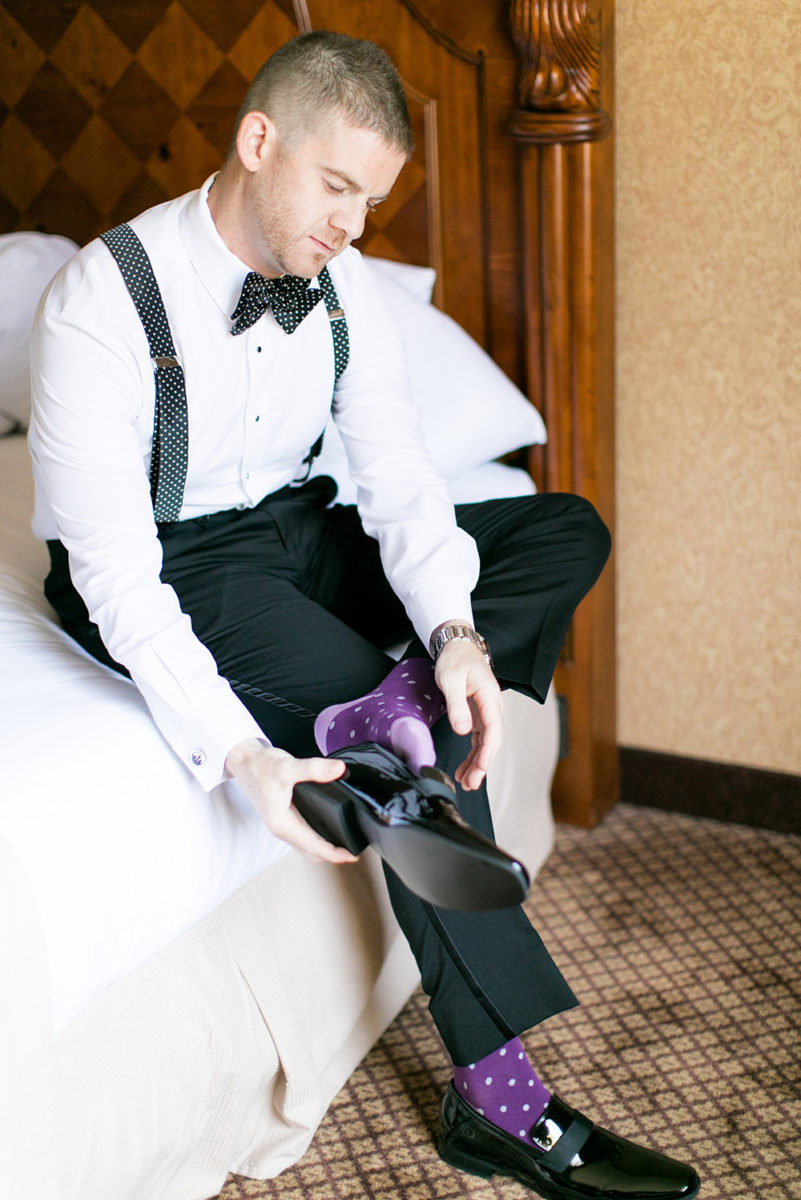 Photos of the groom getting ready on Long Island by Mikkel Paige Photography for her East Wind wedding in Wading River, NY. The wedding venue has a beautiful outdoor ceremony area and pretty indoor reception space. #mikkelpaige #newyorkweddingphotographer #longislandweddingvenue #summer #weddingdetails #gettingready #groomstyle