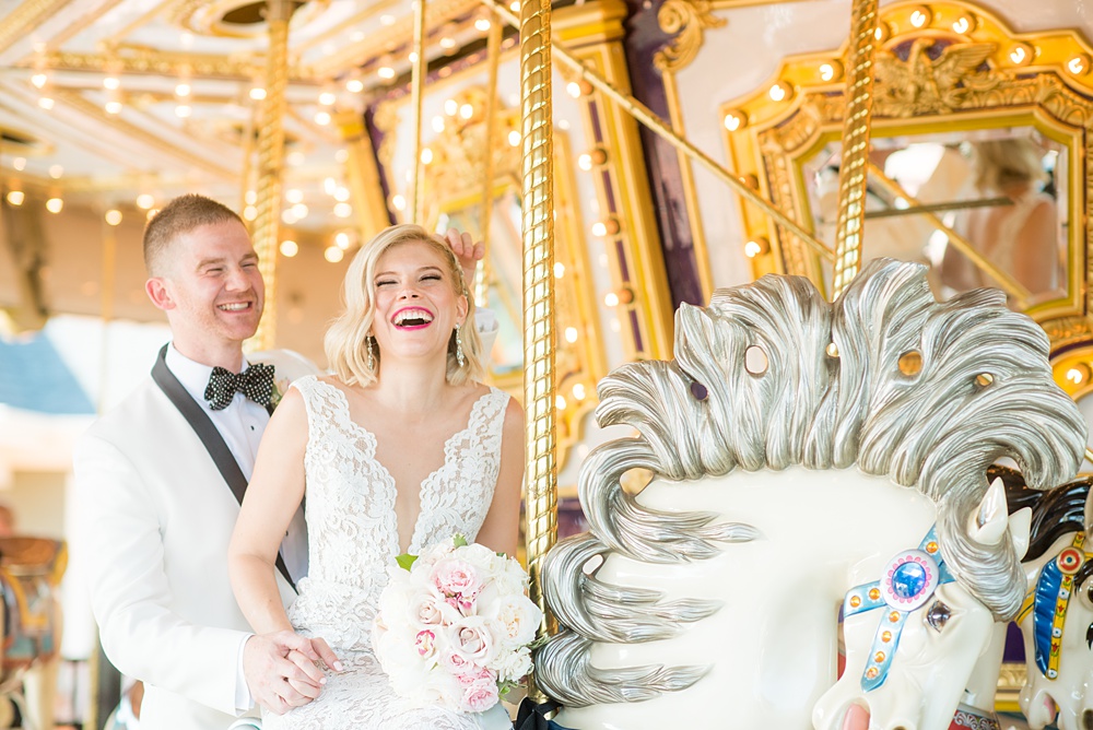 Photos of the bride and groom on a carousel by Mikkel Paige Photography at an East Wind wedding in Wading River, NY on Long Island. The wedding venue has a beautiful outdoor ceremony area and pretty indoor reception space. #mikkelpaige #newyorkweddingphotographer #longislandweddingvenue #summerbride #laceweddinggown #bridestyle #BrideandGroom