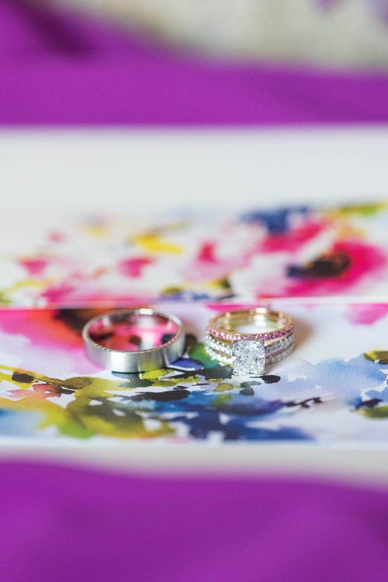 Detail pictures of wedding rings by Mikkel Paige Photography at an East Wind wedding in Wading River, NY on Long Island. The wedding venue has a beautiful outdoor ceremony area and pretty indoor reception space. #mikkelpaige #newyorkweddingphotographer #longislandweddingvenue #weddingrings #purplewedding