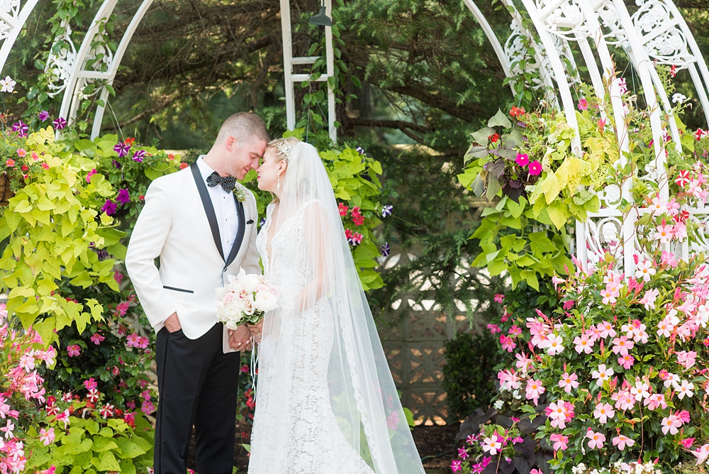 Photos of the bride and groom during a summer event by Mikkel Paige Photography at an East Wind wedding in Wading River, NY on Long Island. The wedding venue has a beautiful outdoor ceremony area and pretty indoor reception space. #mikkelpaige #newyorkweddingphotographer #longislandweddingvenue #brideandgroom