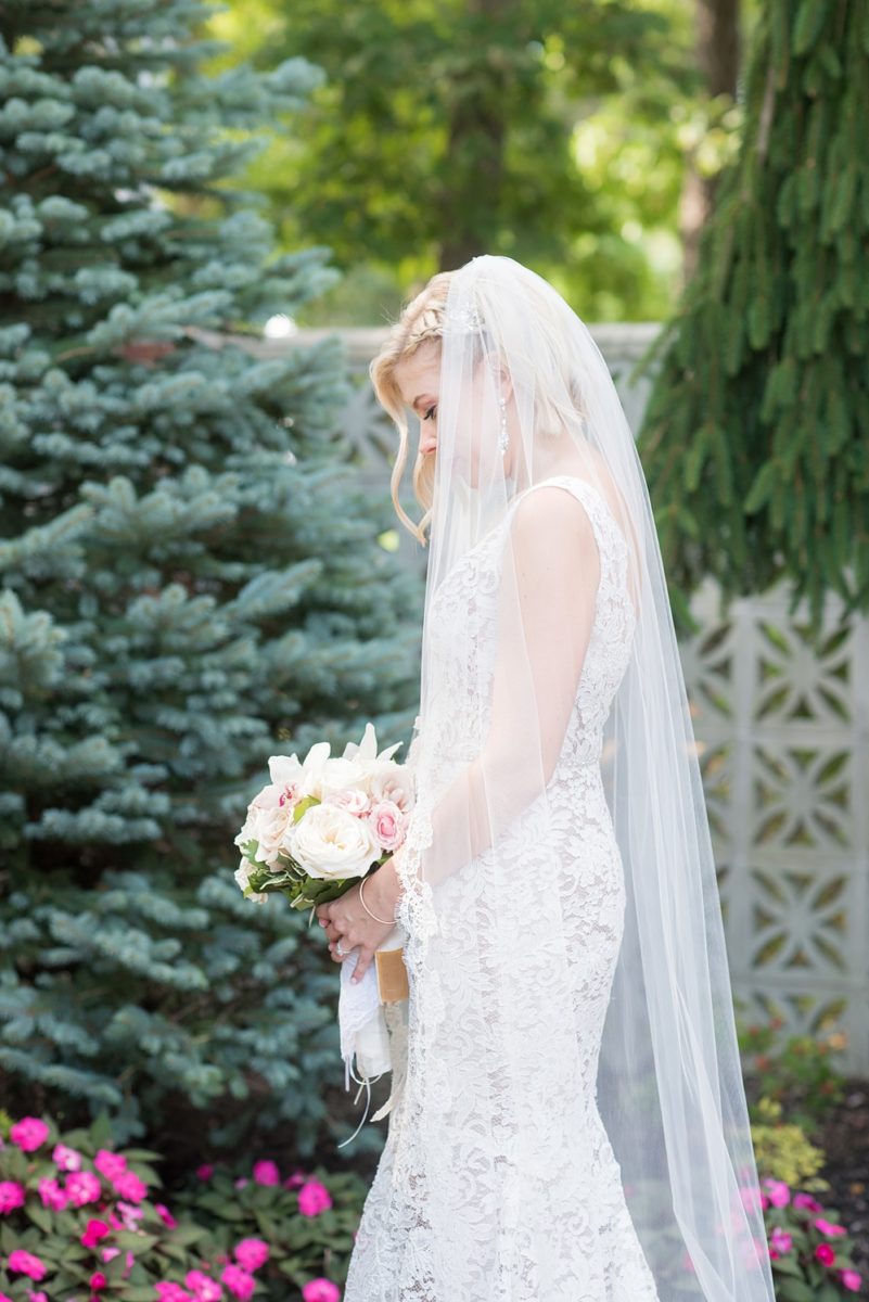 Photos of the bride by Mikkel Paige Photography at an East Wind wedding in Wading River, NY on Long Island. The wedding venue has a beautiful outdoor ceremony area and pretty indoor reception space. #mikkelpaige #newyorkweddingphotographer #longislandweddingvenue #summerbride #laceweddinggown #bridestyle