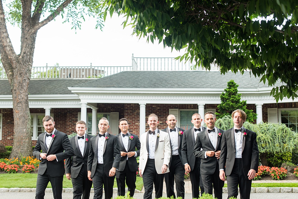 Pictures of the groomsmen in tuxedos by Mikkel Paige Photography at an East Wind wedding in Wading River, NY on Long Island. The wedding venue has a beautiful outdoor ceremony area and pretty indoor reception space. #mikkelpaige #newyorkweddingphotographer #longislandweddingvenue #groomstyle #groomsmen