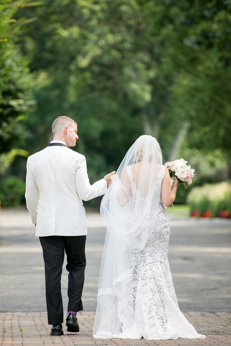 Photos of the bride and groom during a summer event by Mikkel Paige Photography at an East Wind wedding in Wading River, NY on Long Island. The wedding venue has a beautiful outdoor ceremony area and pretty indoor reception space. #mikkelpaige #newyorkweddingphotographer #longislandweddingvenue #brideandgroom