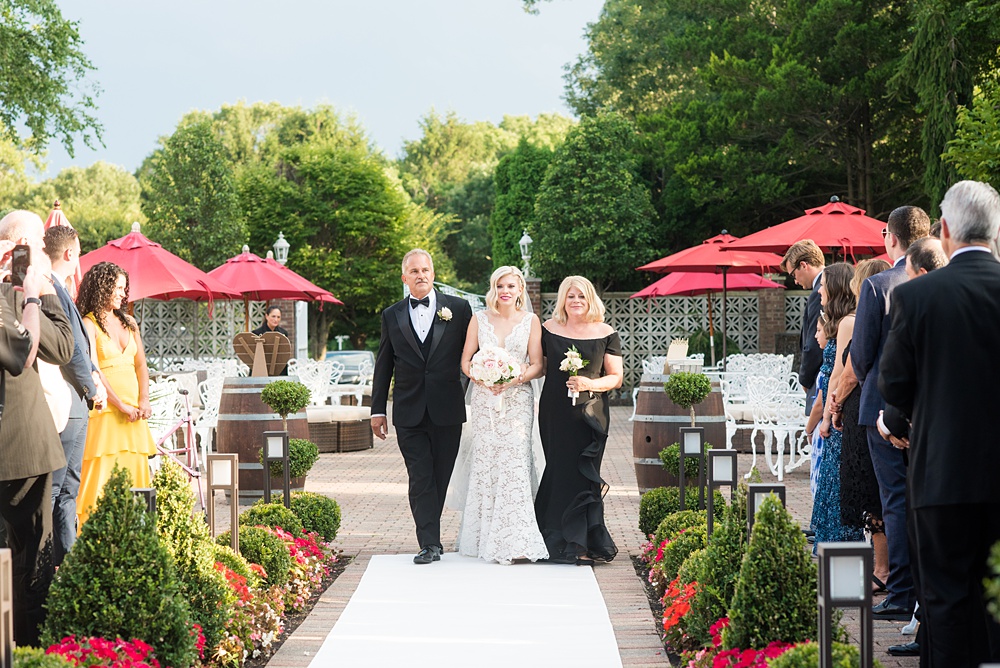 An outdoor ceremony during a summer event, photographed by Mikkel Paige Photography at an East Wind wedding in Wading River, NY on Long Island. The venue has a beautiful indoor reception space as well. #mikkelpaige #newyorkweddingphotographer #longislandweddingvenue #outdoorceremony #ceremony #firstkiss