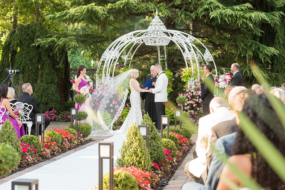 An outdoor ceremony during a summer event, photographed by Mikkel Paige Photography at an East Wind wedding in Wading River, NY on Long Island. The venue has a beautiful indoor reception space as well. #mikkelpaige #newyorkweddingphotographer #longislandweddingvenue #outdoorceremony #ceremony #firstkiss