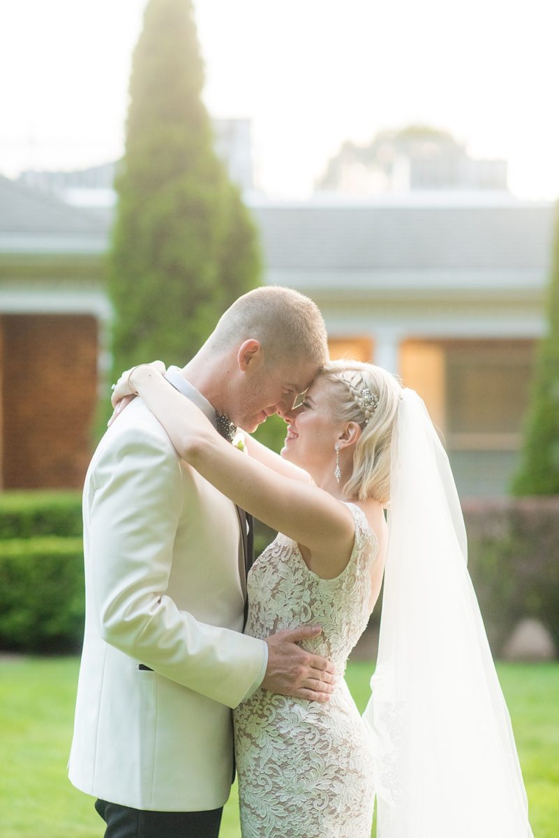 Sunset photos of the bride and groom during a summer event by Mikkel Paige Photography at an East Wind wedding in Wading River, NY on Long Island. The wedding venue has a beautiful outdoor ceremony area and pretty indoor reception space. #mikkelpaige #newyorkweddingphotographer #longislandweddingvenue #brideandgroom #goldenhour