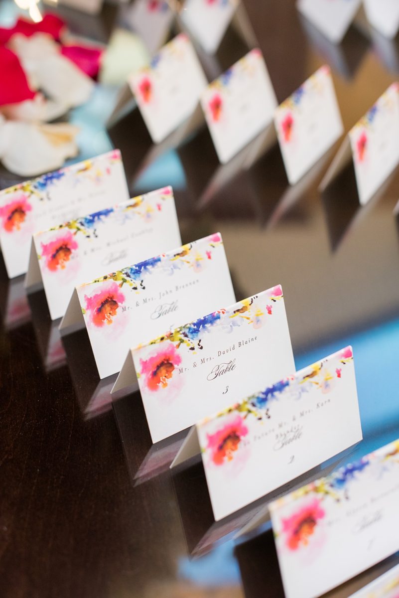 Detail photos of escort cards with a floral pattern by Mikkel Paige Photography of an East Wind wedding in Wading River, NY on Long Island. The wedding venue has a beautiful outdoor ceremony area and pretty indoor reception space. #mikkelpaige #newyorkweddingphotographer #longislandweddingvenue