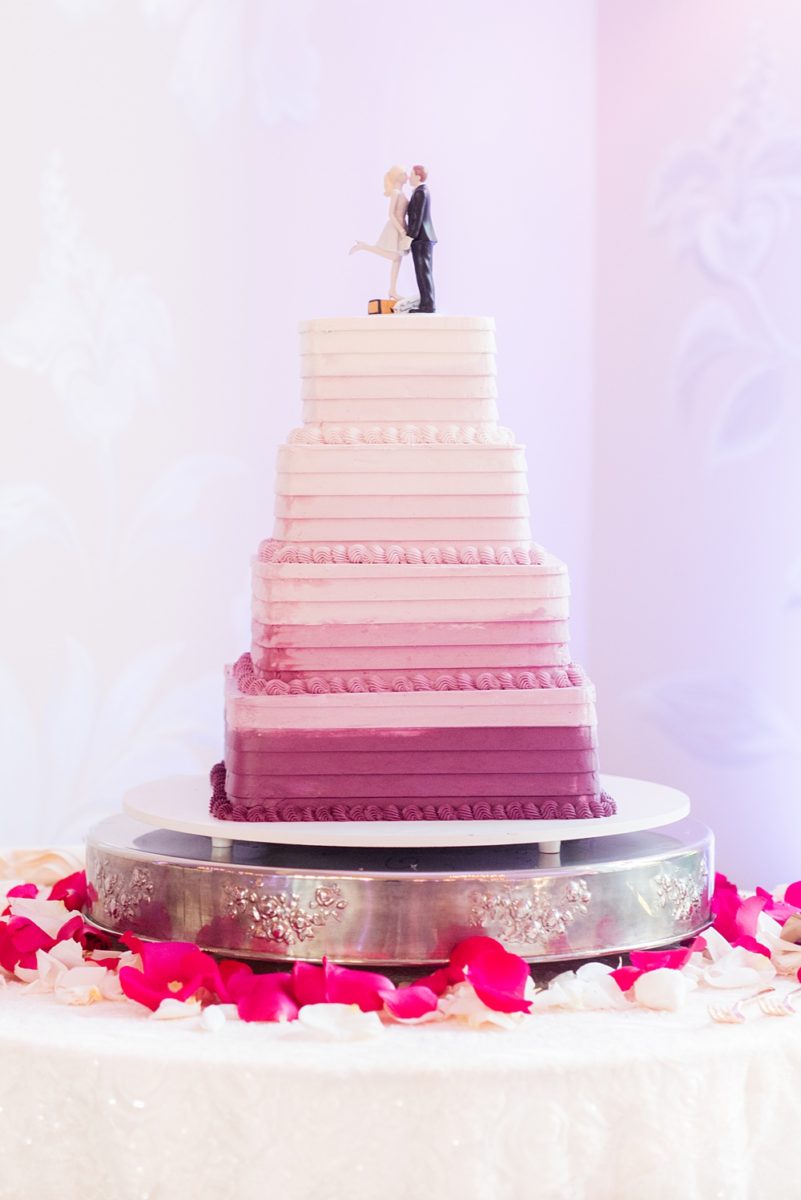 Detail photos of a square purple and pink ombre cake with a bride and groom topper by Mikkel Paige Photography of an East Wind wedding in Wading River, NY on Long Island. The wedding venue has a beautiful outdoor ceremony area and pretty indoor reception space. #mikkelpaige #newyorkweddingphotographer #longislandweddingvenue #ombrecake