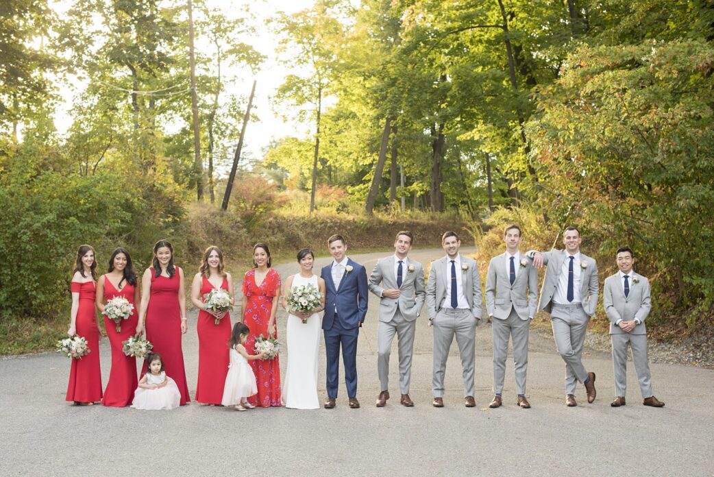 Crabtree's Kittle House wedding photos by Mikkel Paige Photography of a fall wedding in Chappaqua, New York. This is a beautiful indoor and outdoor wedding venue in Westchester county! The wedding party had groomsmen in grey suits and red dressed for the bridesmaids. #mikkelpaige #westchesterweddingvenues #westchesterweddingphotographers #redbridesmaids #weddingparty