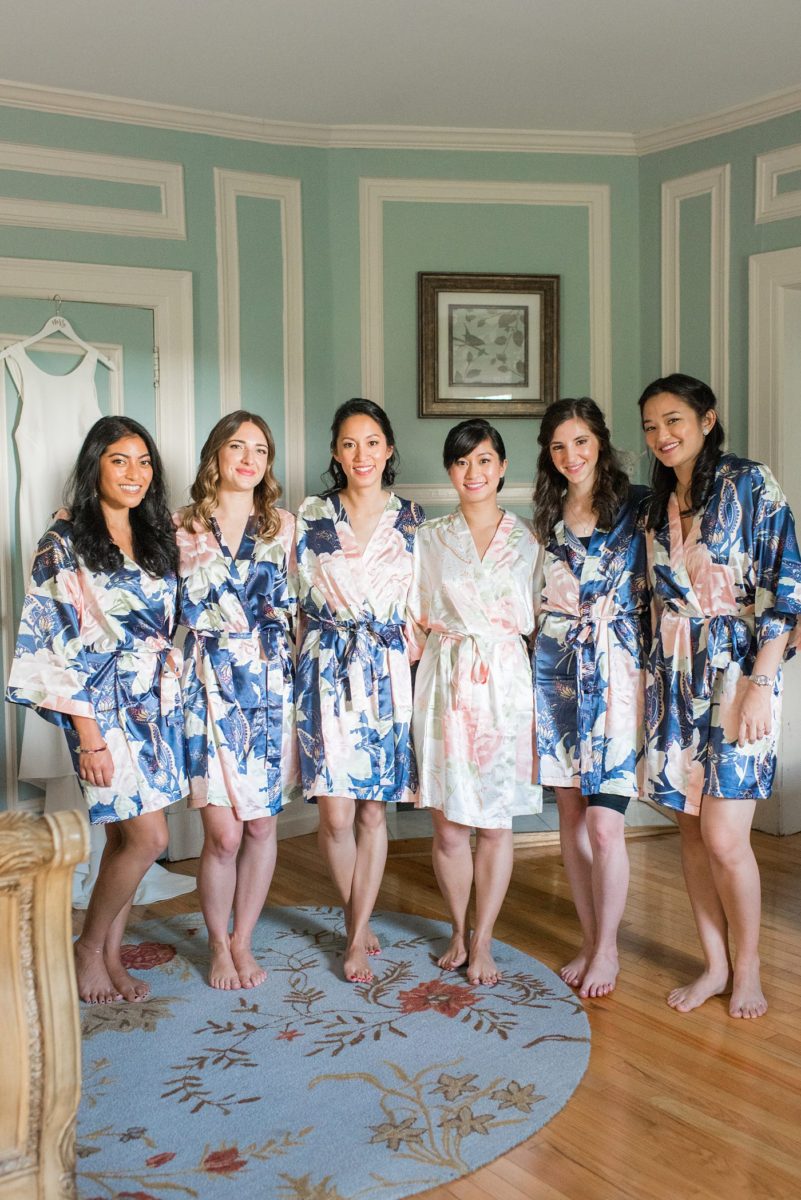 The bride and her bridesmaids got ready for her wedding at Crabtree's Kittle House in Chappaqua, New York at the boutique hotel in floral robes. Photos by Mikkel Paige Photography. This venue in Westchester County is near the Hudson Valley and NYC. She wore an elegant, form-fitting white gown with open back with her hair braided and in a low bun. #mikkelpaige #hudsonvalleyweddings #crabtreeskittlehouse #fallwedding #westchestervenues #bridestyle #filipinobride #weddingday #floralrobes