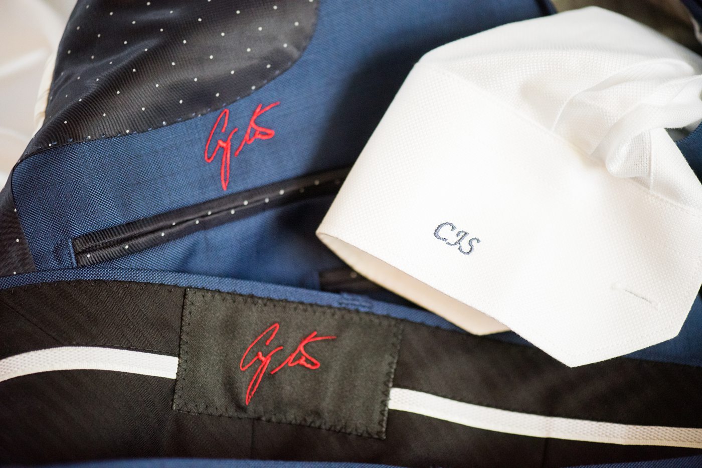 The groom wore a custom blue suit with his signature embroidered in red thread inside and custom initials on the cuffs for his wedding at Crabtree's Kittle House in Chappaqua, New York. Photos by Mikkel Paige Photography. This venue in Westchester County is near the Hudson Valley and NYC. #mikkelpaige #hudsonvalleyweddings #crabtreeskittlehouse #fallwedding #westchestervenues #groom #weddingday #groomstyle #customsuit