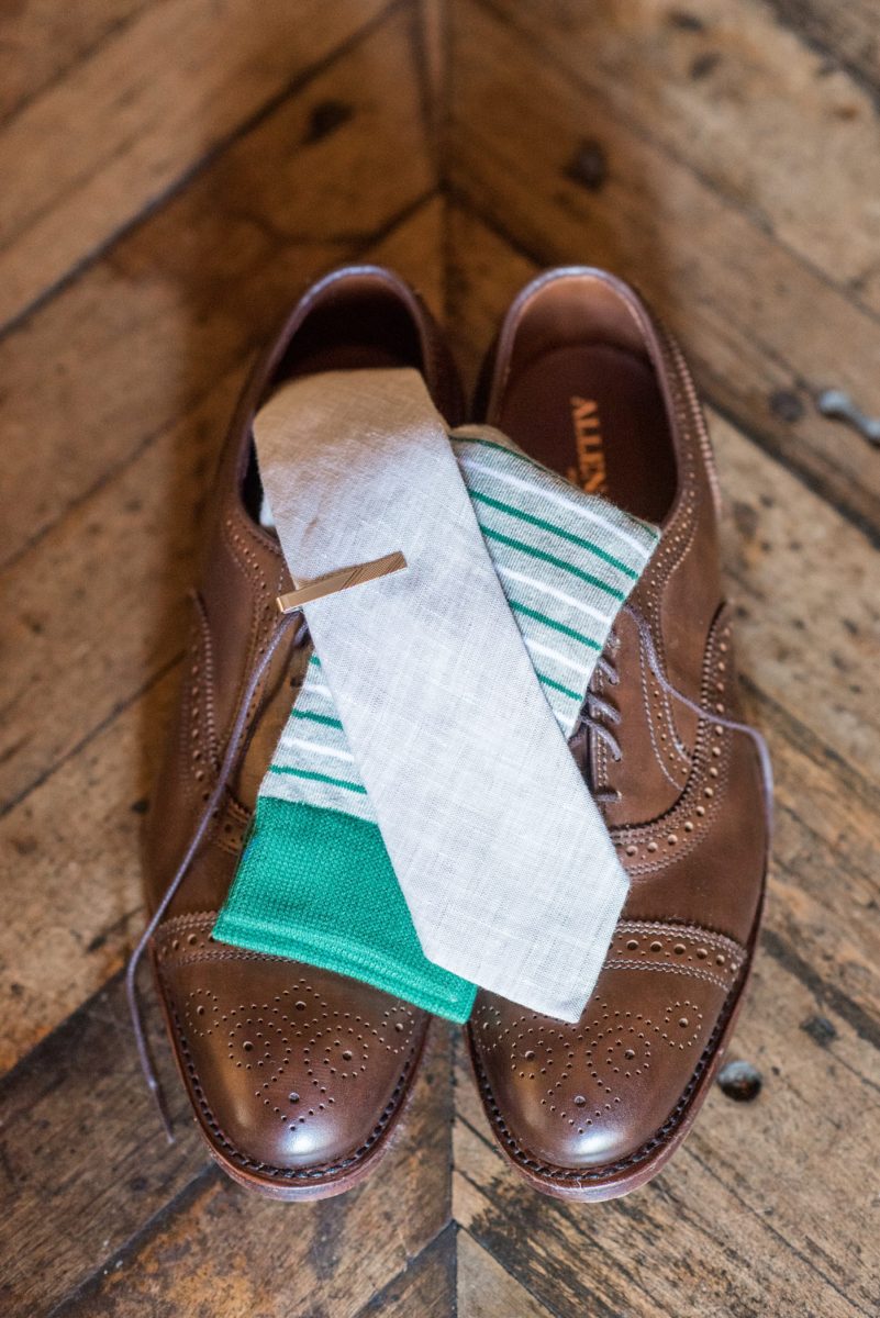 The groom wore a gray tie, brown leather shoes and green striped socks with his blue suit for his wedding at Crabtree's Kittle House in Chappaqua, New York. Photos by Mikkel Paige Photography. This venue in Westchester County is near the Hudson Valley and NYC. #mikkelpaige #hudsonvalleyweddings #crabtreeskittlehouse #fallwedding #westchestervenues #groom #weddingday #groomstyle #customsuit