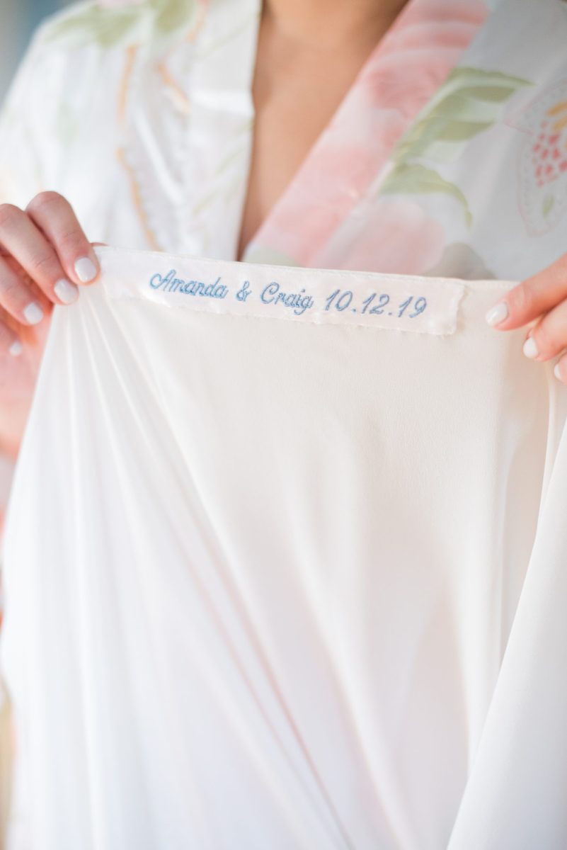 The bride had custom embroidery of their wedding date and names for her "something blue" for her wedding at Crabtree's Kittle House in Chappaqua, New York. Photos by Mikkel Paige Photography. This venue in Westchester County is near the Hudson Valley and NYC. #mikkelpaige #hudsonvalleyweddings #crabtreeskittlehouse #fallwedding #westchestervenues #bridestyle #weddingshoes #veil #weddingday #detailphotos #weddingdetails #somethingblue #weddinggown