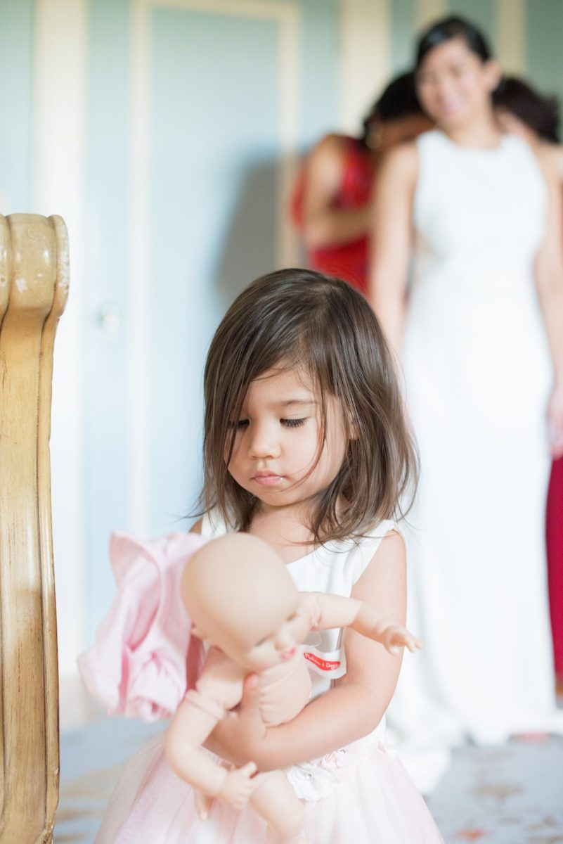 The bride and her bridesmaids and flower girl got ready for her wedding at Crabtree's Kittle House in Chappaqua, New York at the boutique hotel. Photos by Mikkel Paige Photography. This venue in Westchester County is near the Hudson Valley and NYC. She wore an elegant, form-fitting white gown with open back with her hair braided and in a low bun. #mikkelpaige #hudsonvalleyweddings #crabtreeskittlehouse #fallwedding #westchestervenues #bridestyle #filipinobride #gettingready #weddingday