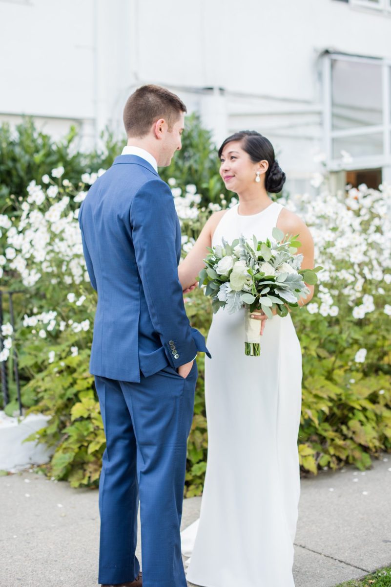 The bride and groom at their Crabtree's Kittle House wedding with an outdoor ceremony and indoor reception in Chappaqua, New York. Photos by Mikkel Paige Photography. This venue in Westchester County is near the Hudson Valley and NYC. She wore an elegant, form-fitting white gown with open back. He wore a blue suit, gray tie and rose boutonniere. #mikkelpaige #hudsonvalleyweddings #crabtreeskittlehouse #fallwedding #westchestervenues #bridestyle #elegantbride #groomstyle #filipinobride