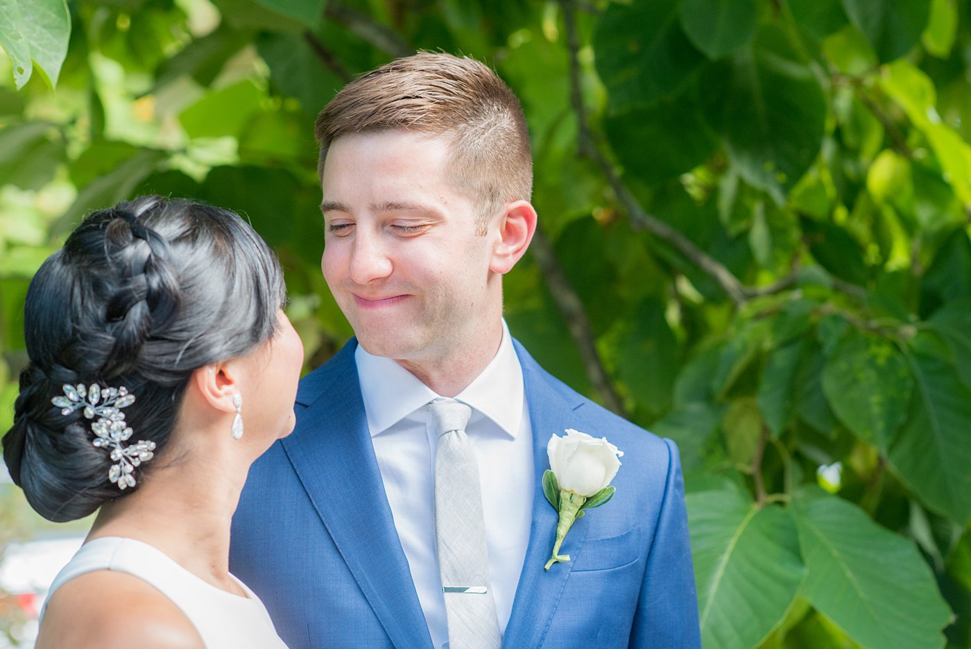 The bride and groom at their Crabtree's Kittle House wedding with an outdoor ceremony and indoor reception in Chappaqua, New York. Photos by Mikkel Paige Photography. This venue in Westchester County is near the Hudson Valley and NYC. She wore an elegant, form-fitting white gown with open back. He wore a gray suit, blue tie and rose boutonniere. #mikkelpaige #hudsonvalleyweddings #crabtreeskittlehouse #fallwedding #westchestervenues #bridestyle #elegantbride #groomstyle #filipinobride