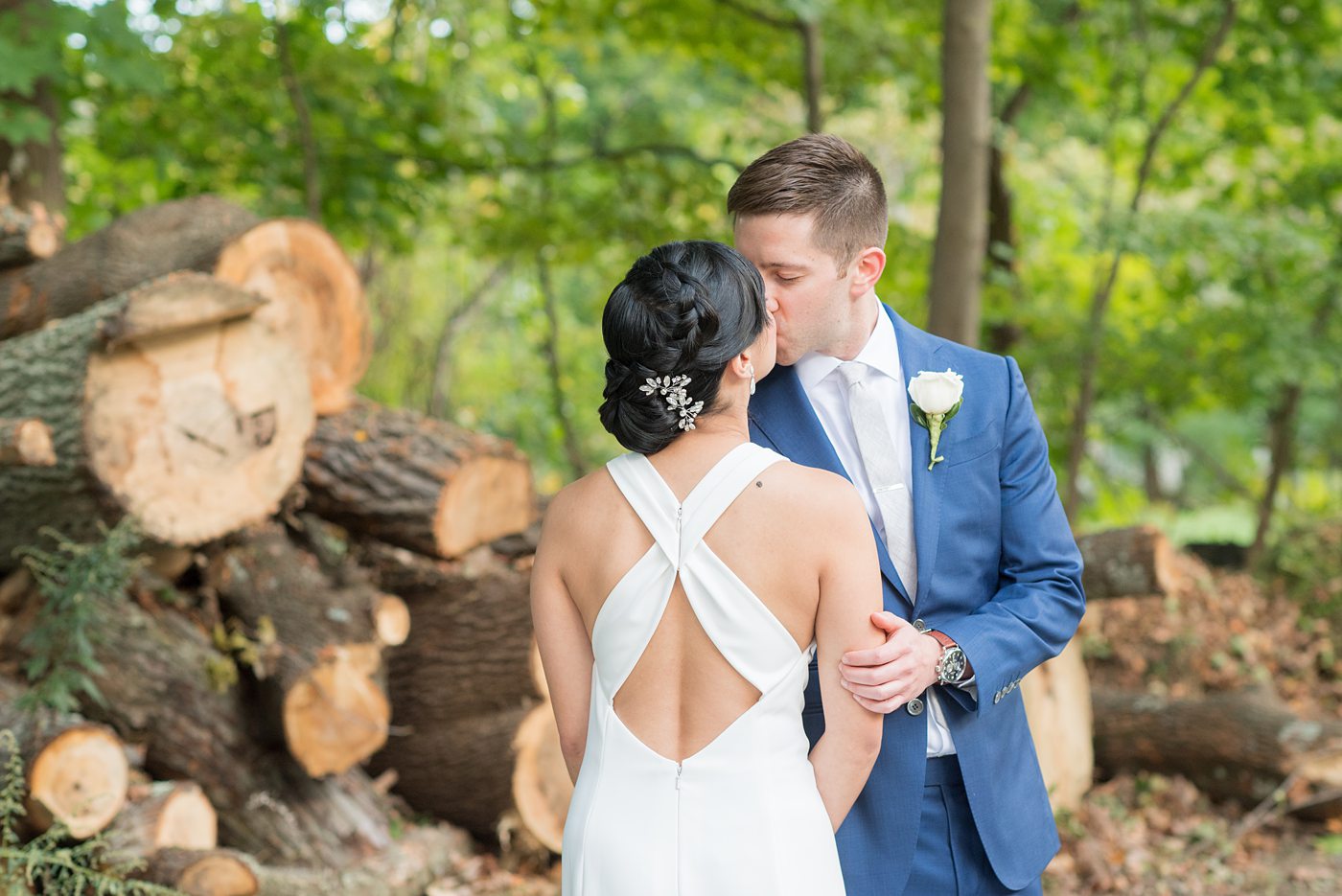 The bride and groom at their Crabtree's Kittle House wedding with an outdoor ceremony and indoor reception in Chappaqua, New York. Photos by Mikkel Paige Photography. This venue in Westchester County is near the Hudson Valley and NYC. She wore an elegant, form-fitting white gown with open back. He wore a blue suit, gray tie and rose boutonniere. #mikkelpaige #hudsonvalleyweddings #crabtreeskittlehouse #fallwedding #westchestervenues #bridestyle #elegantbride #groomstyle #filipinobride