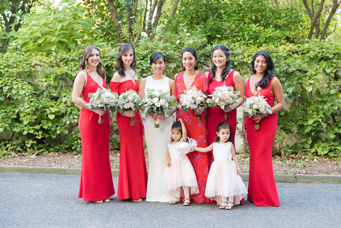 Crabtree's Kittle House wedding with an outdoor ceremony in Chappaqua, New York. Photos by Mikkel Paige Photography. This venue in Westchester County is near the Hudson Valley and NYC. The bride wore a simple form-fitted white gown with open back and bridesmaids wore red in Asian tradition. #mikkelpaige #hudsonvalleyweddings #crabtreeskittlehouse #fallwedding #westchestervenues #redbridesmaids #filipinowedding #bridestyle