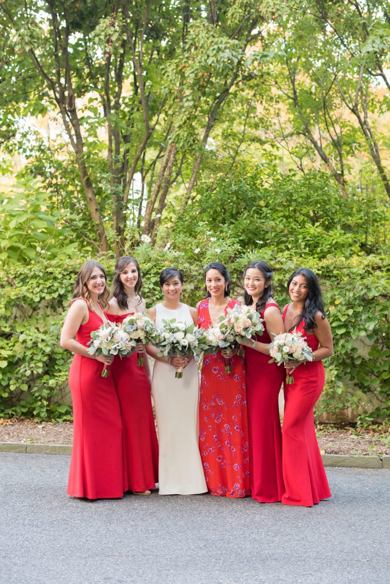 Crabtree's Kittle House wedding with an outdoor ceremony in Chappaqua, New York. Photos by Mikkel Paige Photography. This venue in Westchester County is near the Hudson Valley and NYC. The bride wore a simple form-fitted white gown with open back and bridesmaids wore red in Asian tradition. #mikkelpaige #hudsonvalleyweddings #crabtreeskittlehouse #fallwedding #westchestervenues #redbridesmaids #filipinowedding #bridestyle