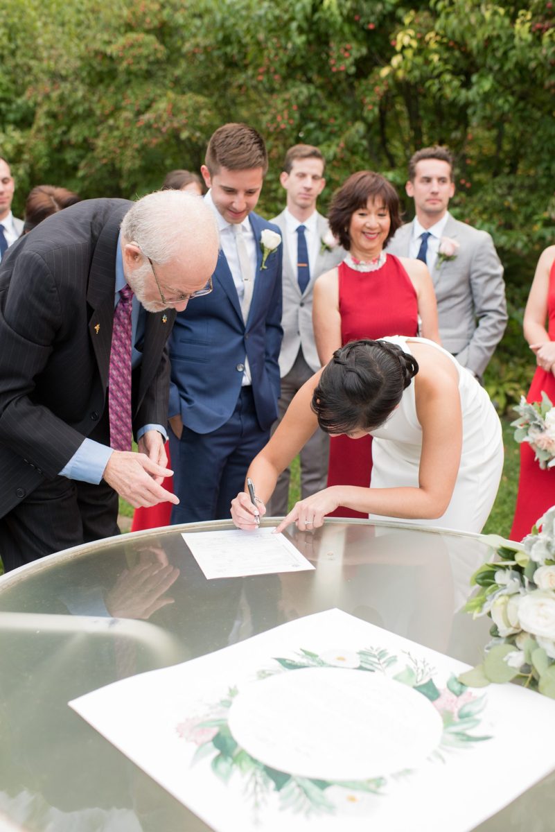 A custom ketubah was watercolored by the bride's friend for an outdoor ceremony at Crabtree's Kittle House in Chappaqua, New York. Photos by Mikkel Paige Photography. This venue in Westchester County is near the Hudson Valley and NYC. The bride and groom incorporated a Rabbi and Priest, and Jewish and Filipino traditions. #mikkelpaige #hudsonvalleyweddings #crabtreeskittlehouse #fallwedding #westchestervenues #ketubah #Jewishwedding