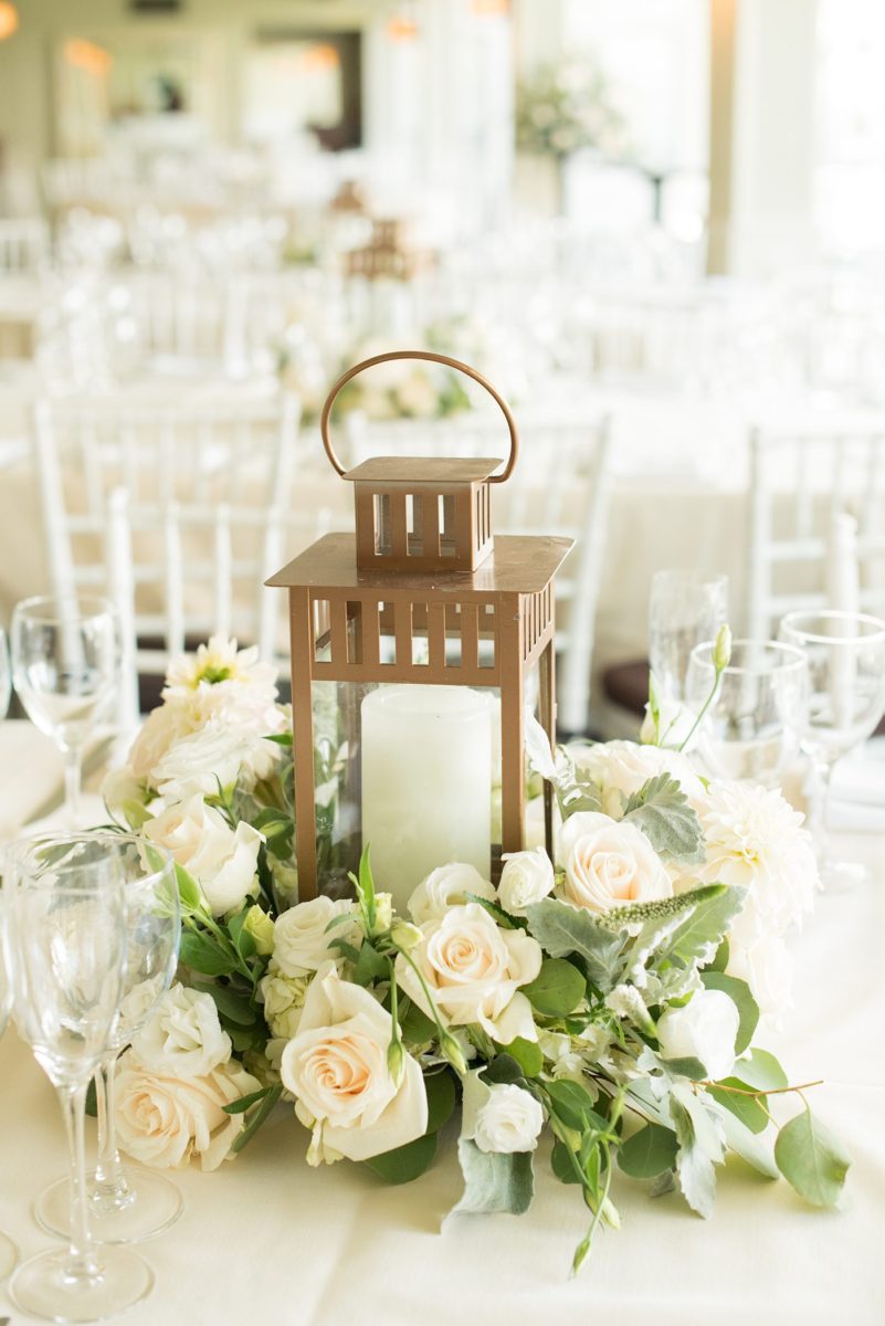 Indoor reception at Crabtree's Kittle House wedding after an outdoor ceremony in Chappaqua, New York. Table photos with lanterns and white dahlia and rose centerpieces by Mikkel Paige Photography. This venue in Westchester County is near the Hudson Valley and NYC. #mikkelpaige #hudsonvalleyweddings #crabtreeskittlehouse #fallwedding #westchestervenues #reception #dahlias #centerpieces