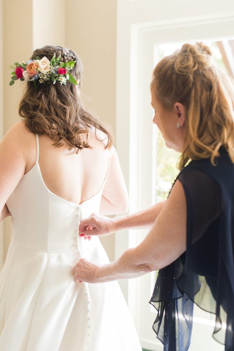 New Jersey wedding venue, Crystal Springs Resort, in Hamburg with an outdoor ceremony option and indoor reception. Photos by Mikkel Paige Photography. The bride wore a simple classic white dress with flowers in her hair. #mikkelpaige #CrystalSprings #NJweddingvenues #NewJerseyWedding #NJweddingphotographer #bridestyle #gettingready