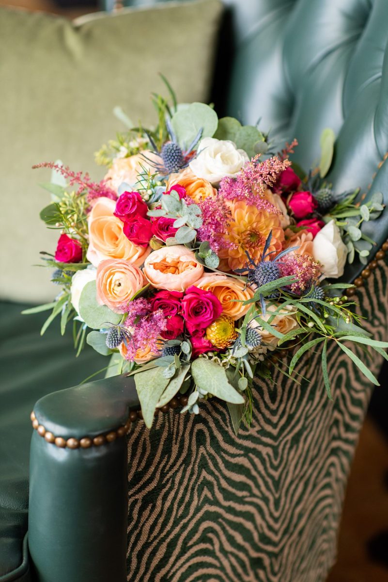 New Jersey wedding venue, Crystal Springs Resort, in Hamburg with an outdoor ceremony option and indoor reception. This detail photo of the bride's bouquet is by Mikkel Paige Photography. It had colorful flowers including blue thistle, orange ranunculus, peach roses, green eucalyptus, mums and sweetheart roses. #mikkelpaige #CrystalSprings #NJweddingvenues #NewJerseyWedding #NJweddingphotographer #bouquet #fallbouquet #autumnbouquet #colorfulbouquet #detailshots #detailphotos 