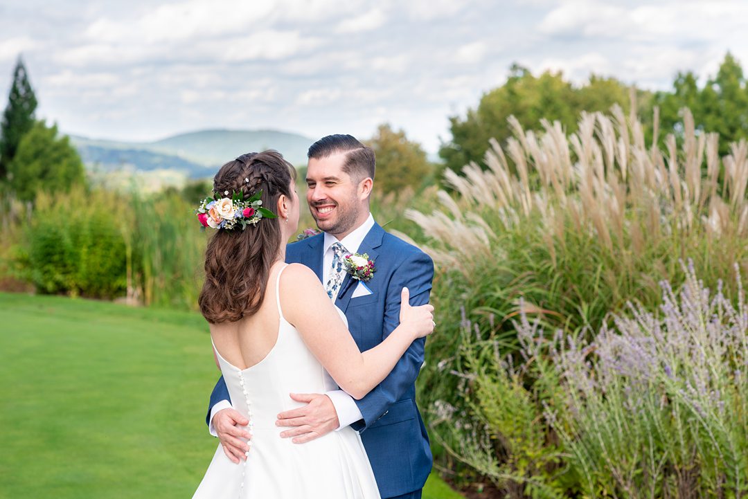 New Jersey wedding venue, Crystal Springs Resort, in Hamburg with an outdoor ceremony option and indoor reception. Photos by Mikkel Paige Photography. The bride wore a simple classic white dress with flowers in her hair and groom a blue suit and floral tie. #mikkelpaige #CrystalSprings #NJweddingvenues #NewJerseyWedding #NJweddingphotographer #brideandgroom