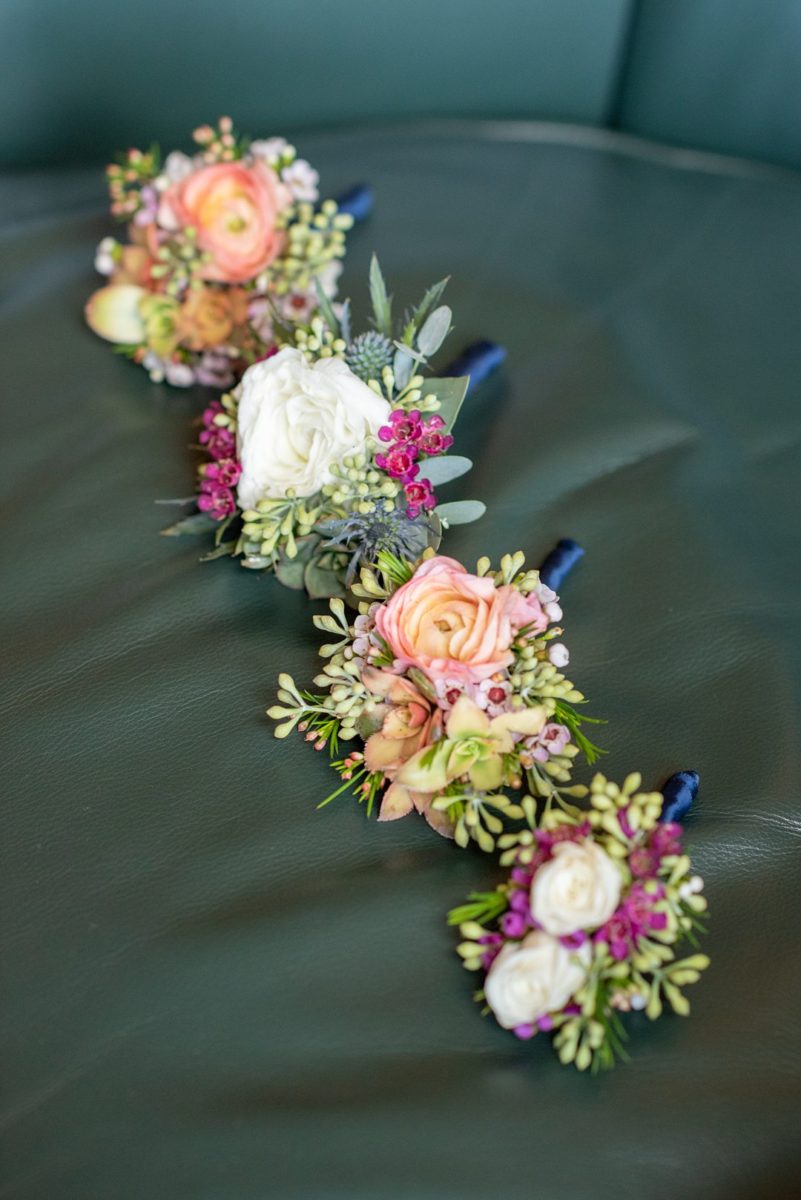 Photos at New Jersey wedding venue, Crystal Springs Resort, in Hamburg with an outdoor ceremony option and indoor reception, by Mikkel Paige Photography. The groom and groomsmen wore colorful boutonnieres with orange ranunculus and green eucalyptus. #mikkelpaige #CrystalSprings #NJweddingvenues #NewJerseyWedding #NJweddingphotographer #boutonnieres #groomstyle #fallwedding