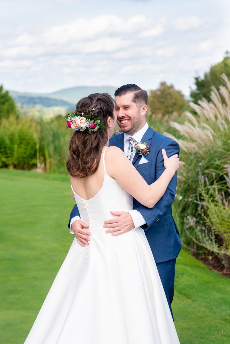 New Jersey wedding venue, Crystal Springs Resort, in Hamburg with an outdoor ceremony option and indoor reception. Photos by Mikkel Paige Photography. The bride wore a simple classic white dress with flowers in her hair and groom a blue suit and floral tie. #mikkelpaige #CrystalSprings #NJweddingvenues #NewJerseyWedding #NJweddingphotographer #brideandgroom