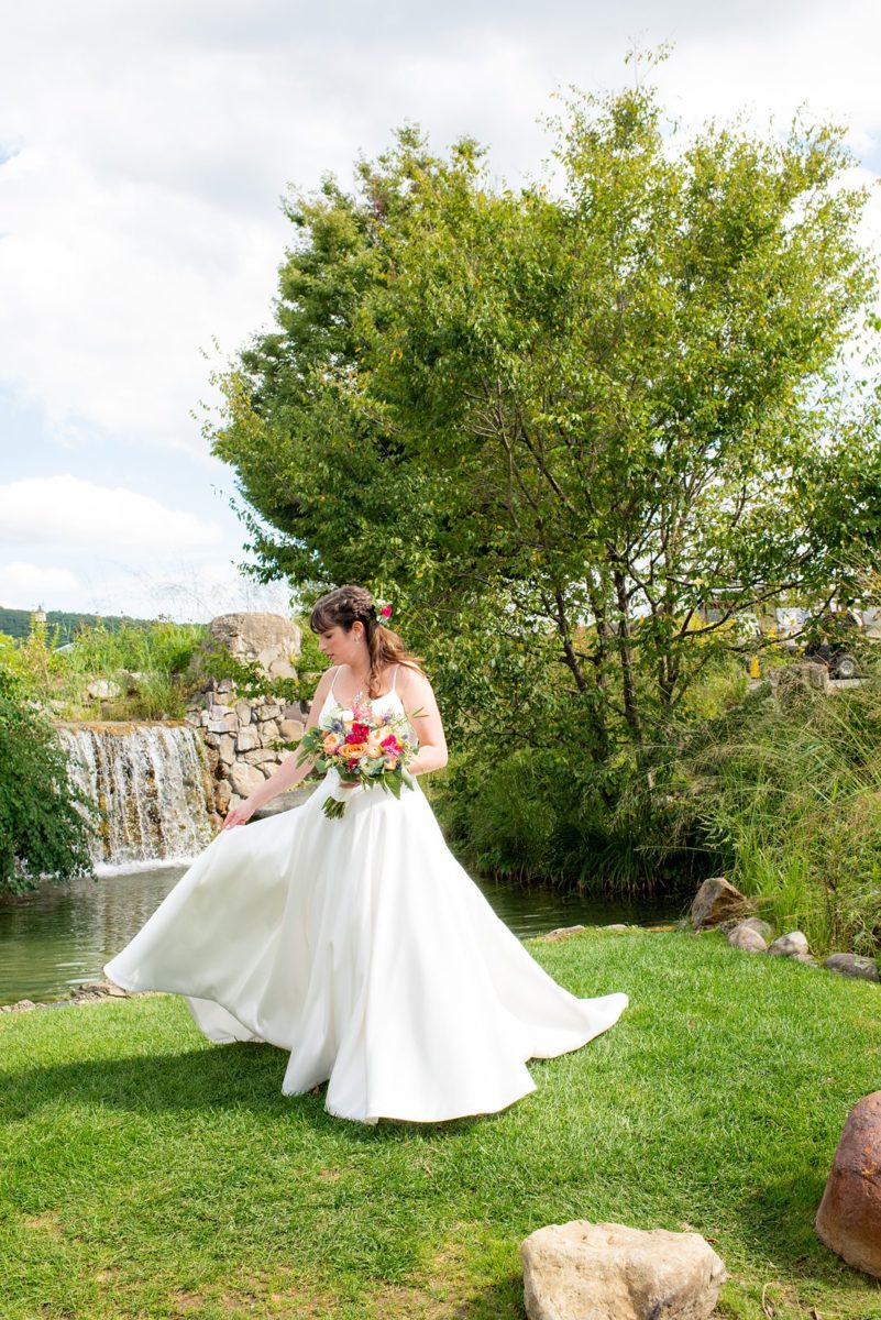New Jersey wedding venue, Crystal Springs Resort, in Hamburg with an outdoor ceremony option and indoor reception. Photos by Mikkel Paige Photography. The bride wore a simple classic white dress with flowers in her hair and groom a blue suit and floral tie. #mikkelpaige #CrystalSprings #NJweddingvenues #NewJerseyWedding #NJweddingphotographer #brideandgroom
