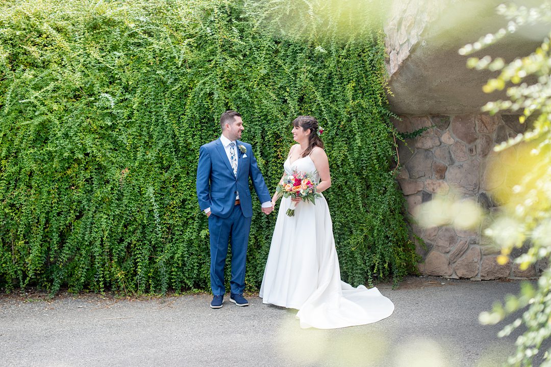New Jersey wedding venue, Crystal Springs Resort, in Hamburg with an outdoor ceremony option and indoor reception. Photos by Mikkel Paige Photography. The bride wore a simple classic white dress with flowers in her hair and groom a blue suit and floral tie. #mikkelpaige #CrystalSprings #NJweddingvenues #NewJerseyWedding #NJweddingphotographer #brideandgroom