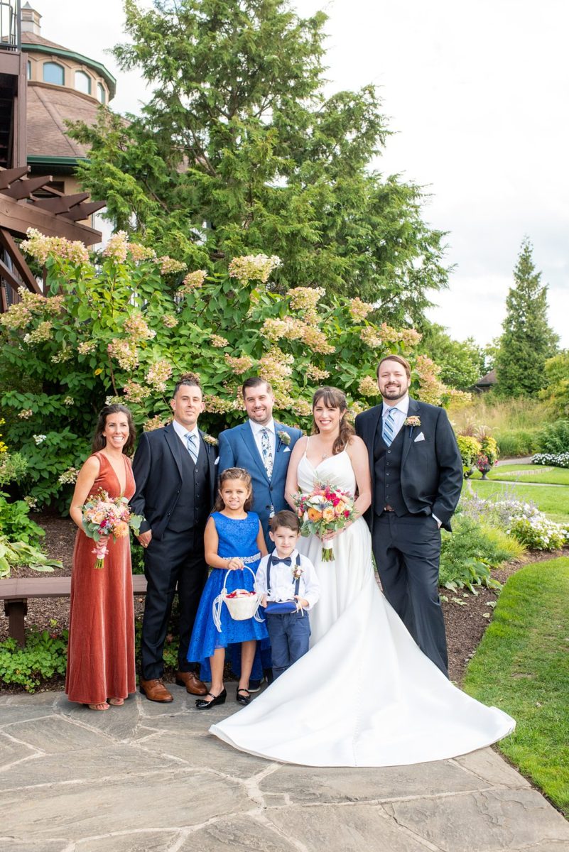 Photos at New Jersey wedding venue, Crystal Springs Resort, in Hamburg with an outdoor ceremony option and indoor reception, by Mikkel Paige Photography. The groom wore a colorful blue suit, bride a simple timeless white gown with spaghetti straps, and they had a small wedding party. Her bridesmaid / Maid of Honor wore an orange rust velvet gown and groomsmen black suits. #mikkelpaige #CrystalSprings #NJweddingvenues #NewJerseyWedding #NJweddingphotographer #fallwedding #velvetdress #rustgown #weddingparty #bridalparty #smallweddingparty #smallbridalparty