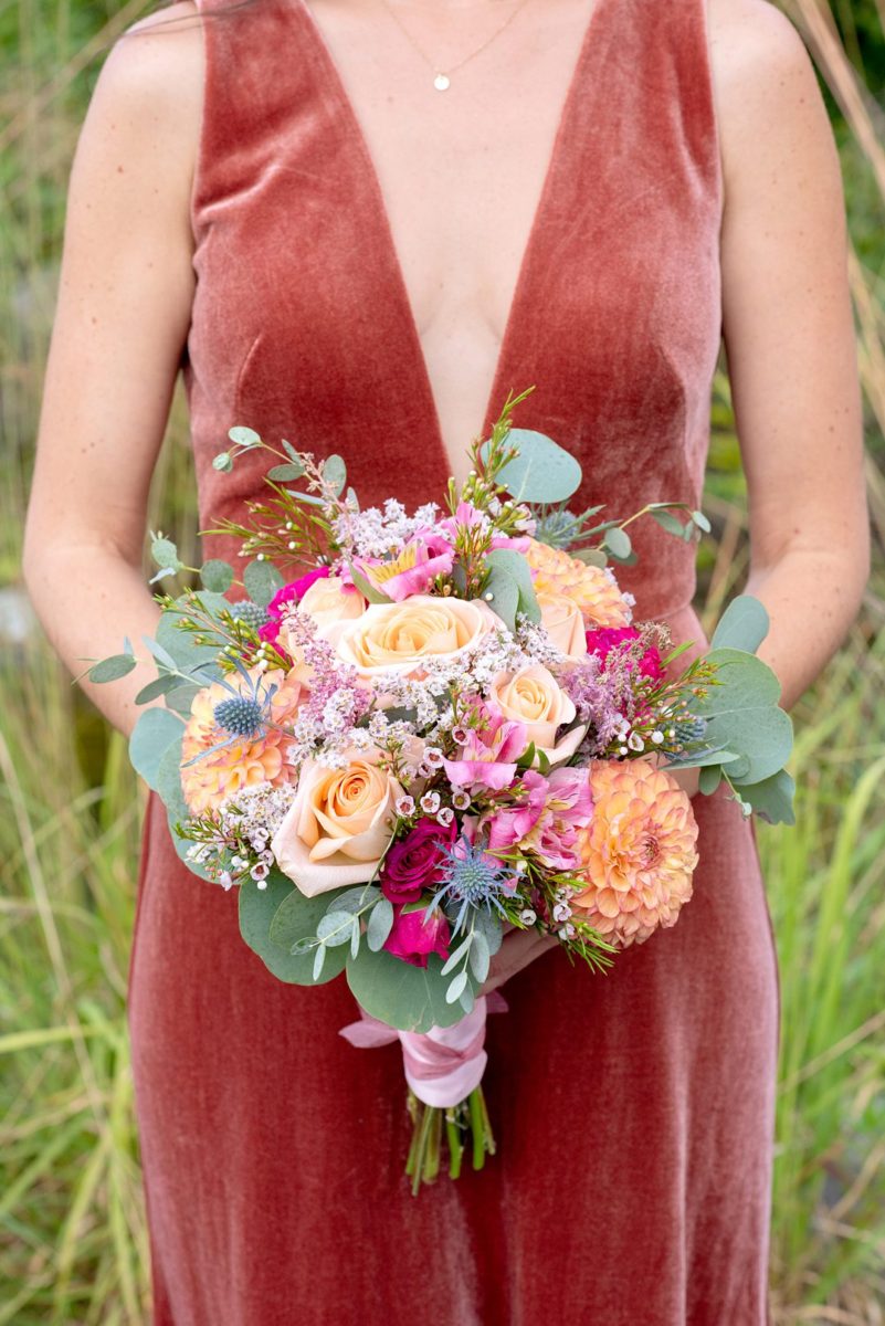 Photos at New Jersey wedding venue, Crystal Springs Resort, in Hamburg with an outdoor ceremony option and indoor reception, by Mikkel Paige Photography. The Maid of Honor wore an orange rust colored velvet gown. She carried colorful bouquets. #mikkelpaige #CrystalSprings #NJweddingvenues #NewJerseyWedding #NJweddingphotographer #fallwedding #velvetdress #rustgown #weddingparty #bridalparty #maidofhonor #bridesmaid #colorfulbouquet