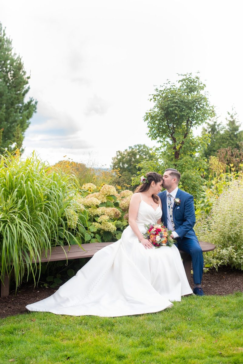 New Jersey wedding venue, Crystal Springs Resort, in Hamburg with an outdoor ceremony option and indoor reception. Photos by Mikkel Paige Photography. The bride wore a simple classic white dress with flowers in her hair and groom a blue suit and floral tie. #mikkelpaige #CrystalSprings #NJweddingvenues #NewJerseyWedding #NJweddingphotographer #brideandgroom