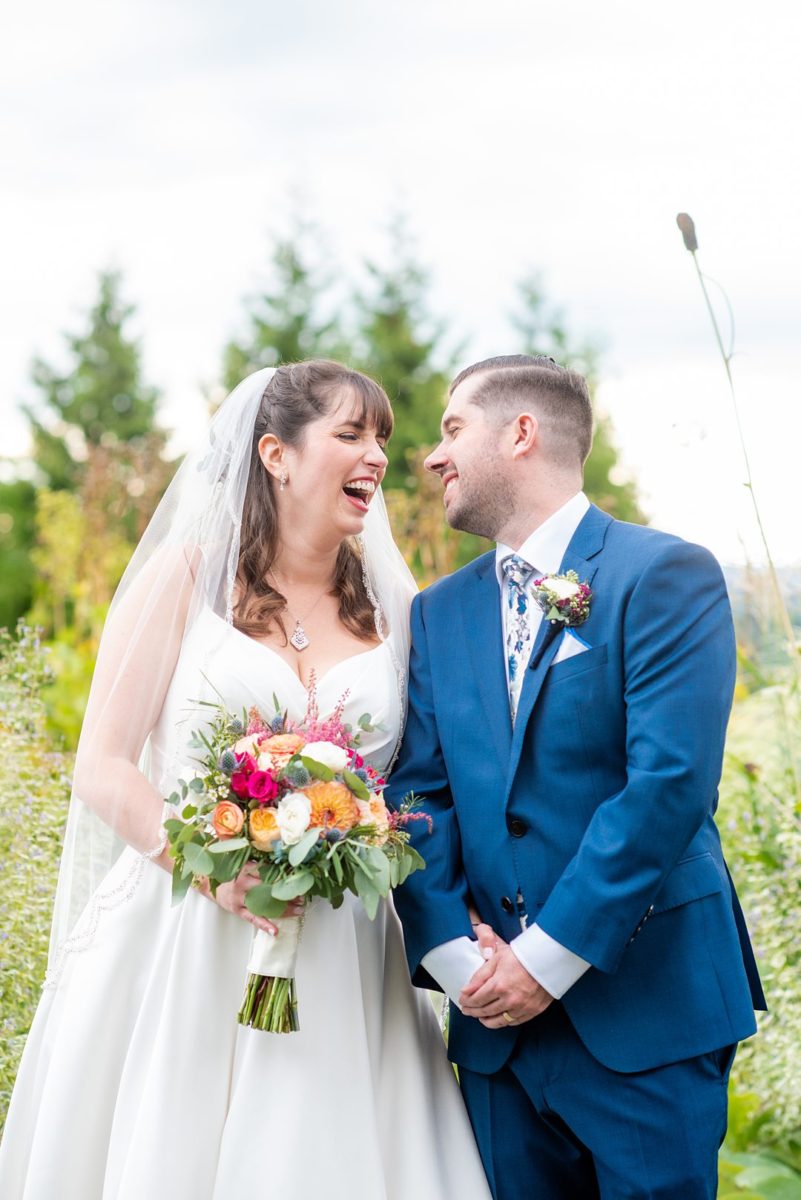 New Jersey wedding venue, Crystal Springs Resort, in Hamburg with an outdoor ceremony option and indoor reception. Photos by Mikkel Paige Photography. The bride wore a simple classic white dress with flowers in her hair and groom a blue suit and floral tie. #mikkelpaige #CrystalSprings #NJweddingvenues #NewJerseyWedding #NJweddingphotographer #brideandgroom